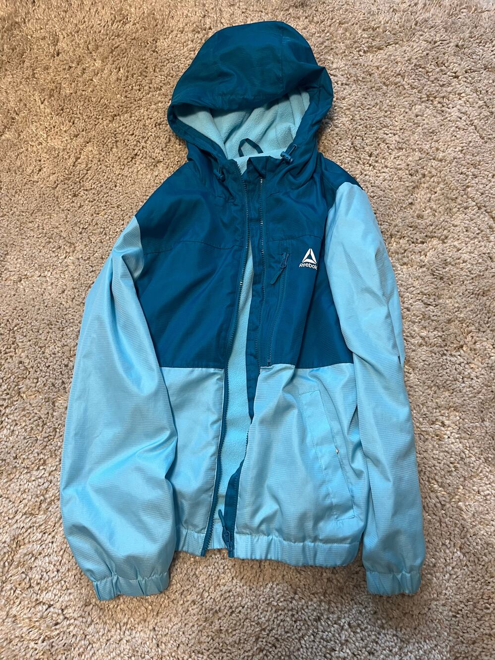 Reebok blue hooded full zip jacket with fleece lining and zip pockets, size L
